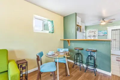 a kitchen with a table and chairs and a counter at Pacific Sunrise in San Diego