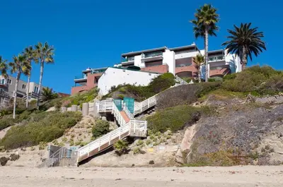 a house on top of a hill next to the beach at Laguna Surf in Laguna Beach