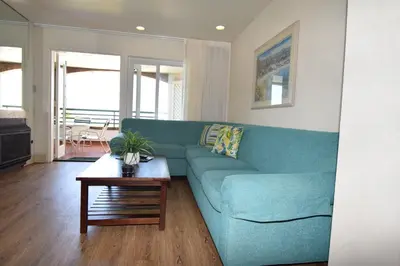 a blue couch in a living room with a table at Laguna Surf in Laguna Beach