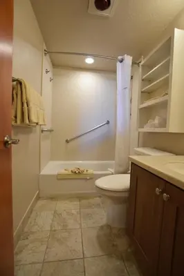a bathroom with a toilet and a tub and a sink at Laguna Surf in Laguna Beach