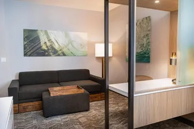 a living room with a couch and a table at SpringHill Suites by Marriott Irvine Lake Forest in Lake Forest