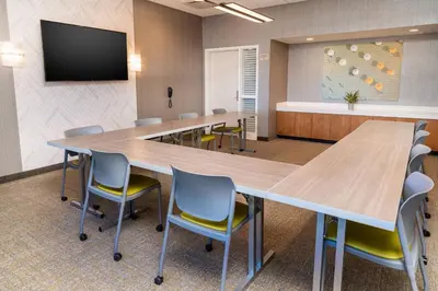 a large conference room with a large table and chairs at SpringHill Suites by Marriott Irvine Lake Forest in Lake Forest
