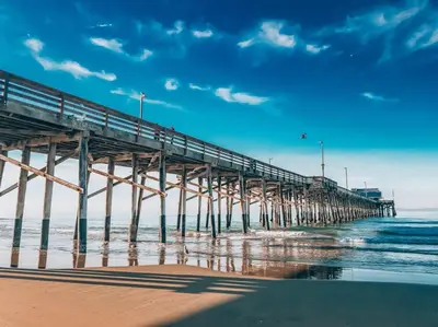 a pier on a beach with the ocean at 1000#1 Contemporary Home w/ Parking, Grill, & AC! in Newport Beach