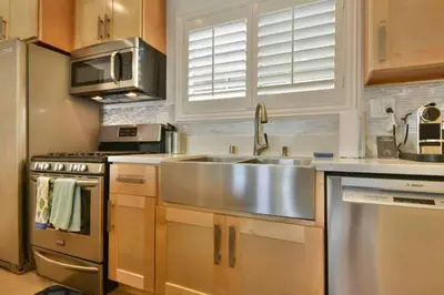 a kitchen with a stainless steel sink and a stove at 1000#2 Magnificent Beach Home w/ AC & 4K TVs in Newport Beach