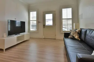 a living room with a couch and a flat screen tv at 1000#2 Magnificent Beach Home w/ AC & 4K TVs in Newport Beach