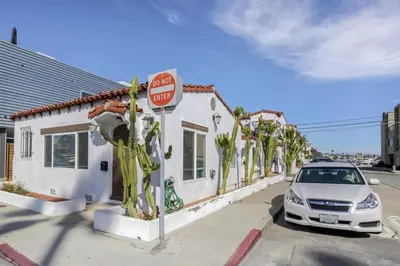 a car parked in front of a building with a stop sign at 1000#4 Modern Beach Home, Steps from Sand w/AC! in Newport Beach