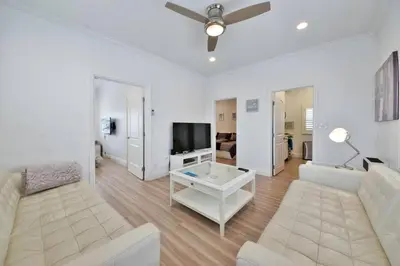 a living room with a couch and a tv at 1000#5 Premier Modern Home w View, Parking, and AC in Newport Beach