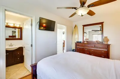 a bedroom with a bed and a ceiling fan at Tropical Oceanside Home with Deck, Walk to Beach in Oceanside