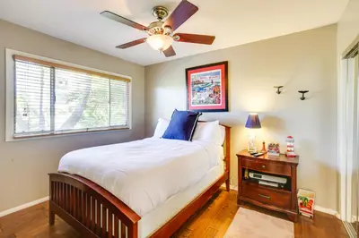 a bedroom with a bed and a ceiling fan at Tropical Oceanside Home with Deck, Walk to Beach in Oceanside