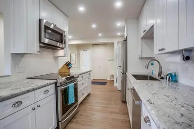 a kitchen with white cabinets and a counter top at Coastal Chic Style Condo SBTC 128 in Solana Beach