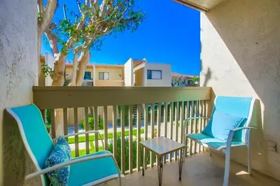 two chairs and a table on a balcony at Coastal Chic Style Condo SBTC 128 in Solana Beach