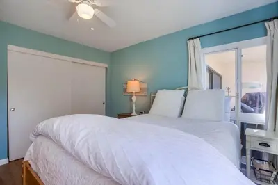 a bedroom with a white bed and a window at Coastal Chic Style Condo SBTC 128 in Solana Beach