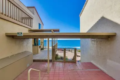 a house with a balcony with a view of the beach at Coastal Chic Style Condo SBTC 128 in Solana Beach