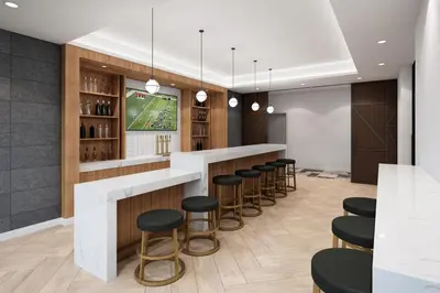 a bar with stools and a tv in a room at Staybridge Suites - Temecula - Wine Country by IHG in Temecula