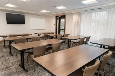 a classroom with tables and chairs and a screen at Staybridge Suites - Temecula - Wine Country by IHG in Temecula