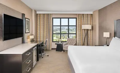 a hotel room with a bed and a desk and a television at Hyatt Regency La Jolla at Aventine in San Diego
