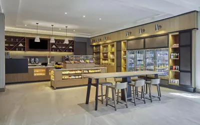 a kitchen with a table and stools at Hyatt Regency La Jolla at Aventine in San Diego
