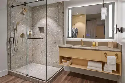 a bathroom with a shower and a sink at Mission Pacific Beach Resort, part of JdV by Hyatt in Oceanside