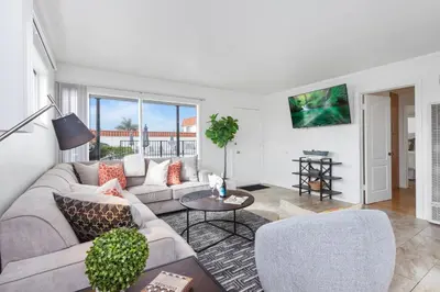 a living room with a couch and a table at Victoria #5 in San Clemente