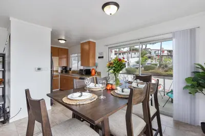 a kitchen and dining room with a table and chairs at Victoria #5 in San Clemente