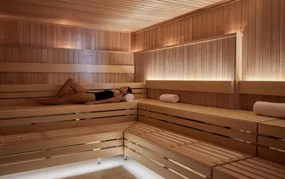 a woman is laying in a sauna at The Seabird Ocean Resort & Spa, Part of Destination Hotel by Hyatt in Oceanside