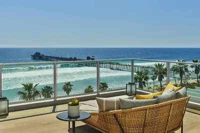 a balcony with chairs and a view of the ocean at The Seabird Ocean Resort & Spa, Part of Destination Hotel by Hyatt in Oceanside