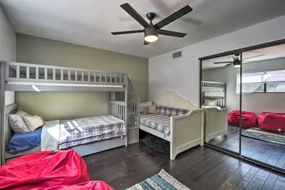 a room with two bunk beds and a ceiling fan at Spacious El Cajon Villa - 14 Mi to Downtown! in El Cajon