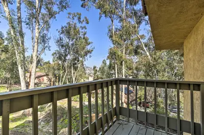 a balcony of a house with trees in the background at Spacious El Cajon Villa - 14 Mi to Downtown! in El Cajon