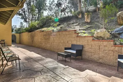 a patio with chairs and a brick wall at Spacious El Cajon Villa - 14 Mi to Downtown! in El Cajon