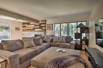 a living room with a couch and a fireplace at Spacious El Cajon Villa - 14 Mi to Downtown! in El Cajon