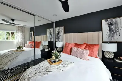 a bedroom with two beds and a large mirror at Luxury Cardiff by-the-Sea Ocean View Penthouse in Encinitas