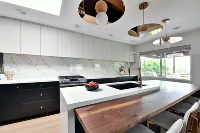 a kitchen with white cabinets and a wooden counter top at Luxury Cardiff by-the-Sea Ocean View Penthouse in Encinitas