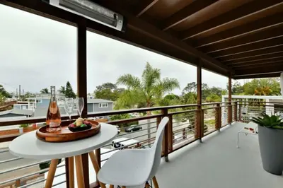 a room with a balcony with a table and chairs at Luxury Cardiff by-the-Sea Ocean View Penthouse in Encinitas
