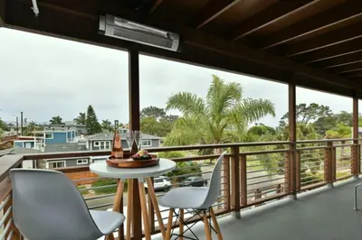 a room with a balcony with a table and chairs at Luxury Cardiff by-the-Sea Ocean View Penthouse in Encinitas