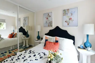 a bedroom with a white bed with a large mirror at Luxury Cardiff by-the-Sea Ocean View Parkhouse in Cardiff-by-the-Sea