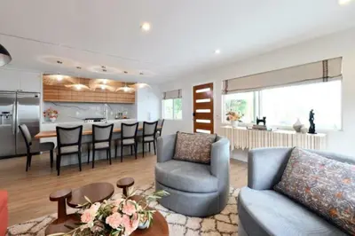 a living room and kitchen with a couch and chairs at Luxury Cardiff by-the-Sea Ocean View Parkhouse in Cardiff-by-the-Sea