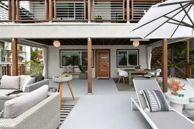 an outdoor patio with couches and an umbrella at Luxury Cardiff by-the-Sea Ocean View Parkhouse in Cardiff-by-the-Sea