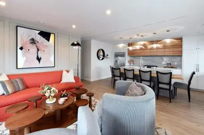 a living room with a red couch and a kitchen at Luxury Cardiff by-the-Sea Ocean View Parkhouse in Cardiff-by-the-Sea
