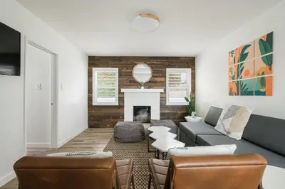 a living room with a couch and a fireplace at The Marbella in Oceanside