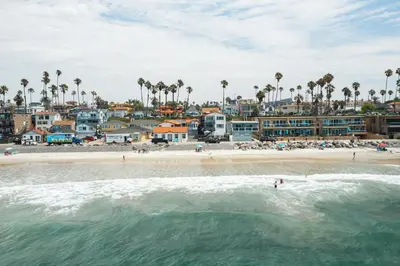 a view of a beach with people in the water at The Marbella in Oceanside