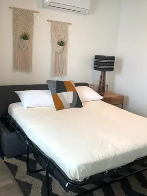 a bed in a room with two vases on the wall at The Marbella in Oceanside