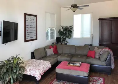 a living room with a couch and a table at Beautiful new detached casita nestled in scenic southern CA foothills! in Fallbrook