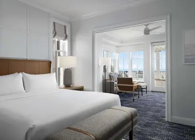 a bedroom with a bed and a desk and a chair at Beach Village at The Del, LXR Hotels & Resorts in San Diego