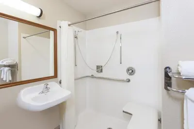 a bathroom with a sink and a mirror at Days Inn by Wyndham Carlsbad in Carlsbad