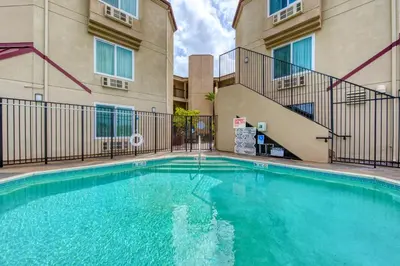 a swimming pool in front of a building at Days Inn by Wyndham Carlsbad in Carlsbad