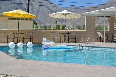 a swimming pool with an inflatable pool noodle in the middle at Borrego Springs Motel in Borrego Springs