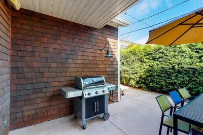 a grill sitting on a patio next to a brick wall at Sycamore Beach Retreat in Carlsbad