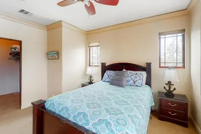 a bedroom with a bed and a ceiling fan at 329 Oak Ave in Carlsbad