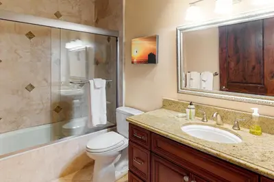 a bathroom with a toilet and a sink and a shower at 329 Oak Ave in Carlsbad