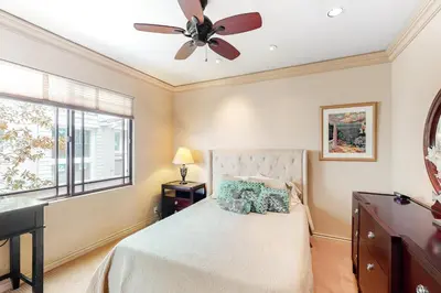 a bedroom with a bed with a ceiling fan at 329 Oak Ave in Carlsbad